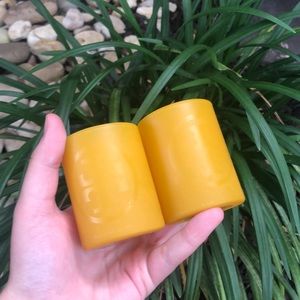 Tory Burch yellow candleholders.